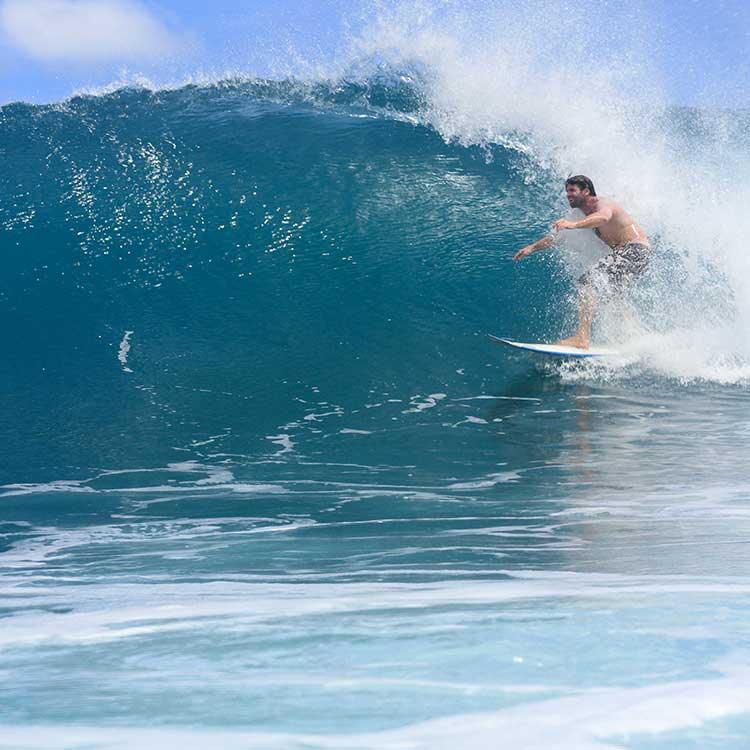 Miguel, Founder Of Good Feeling Surf School, Riding A Wave